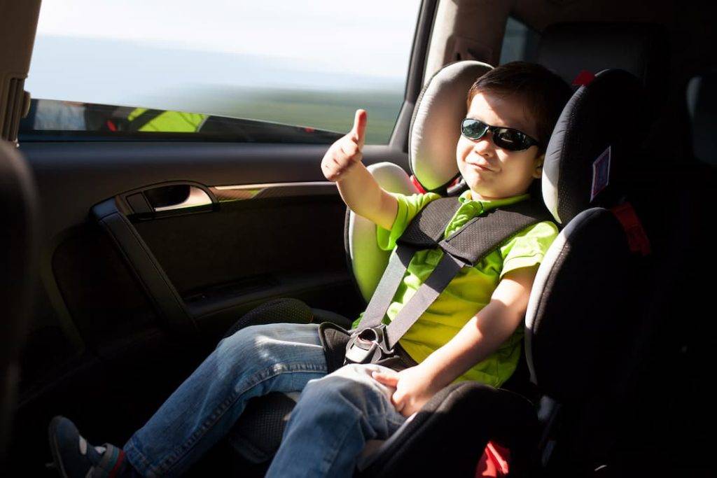 Child In Car With Safety Belt And Car Accessories